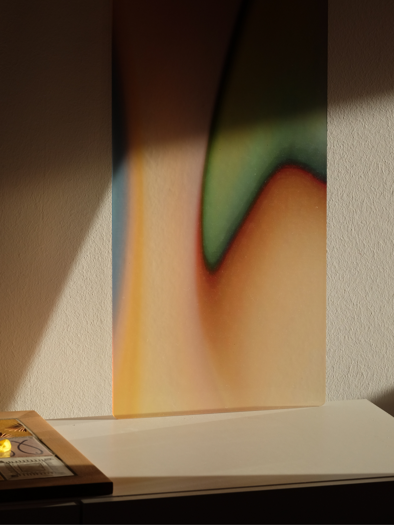 Close-up of a Luis West acrylic glass artwork, colour carried on a translucent acrylic sheet