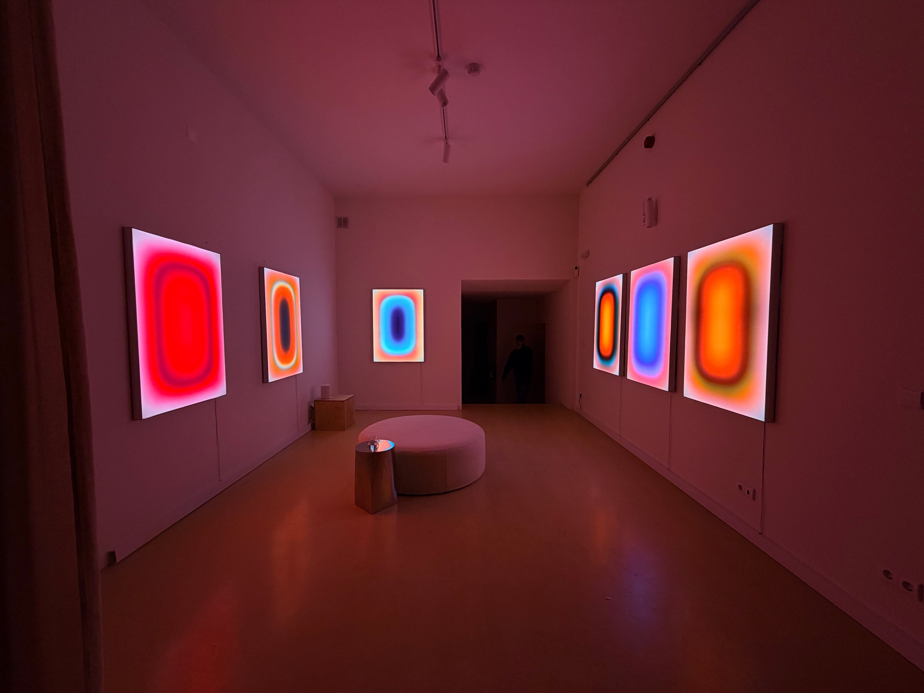Six lightboxes by Luis West lining the walls of the AETHOS exhibition in Lisbon
