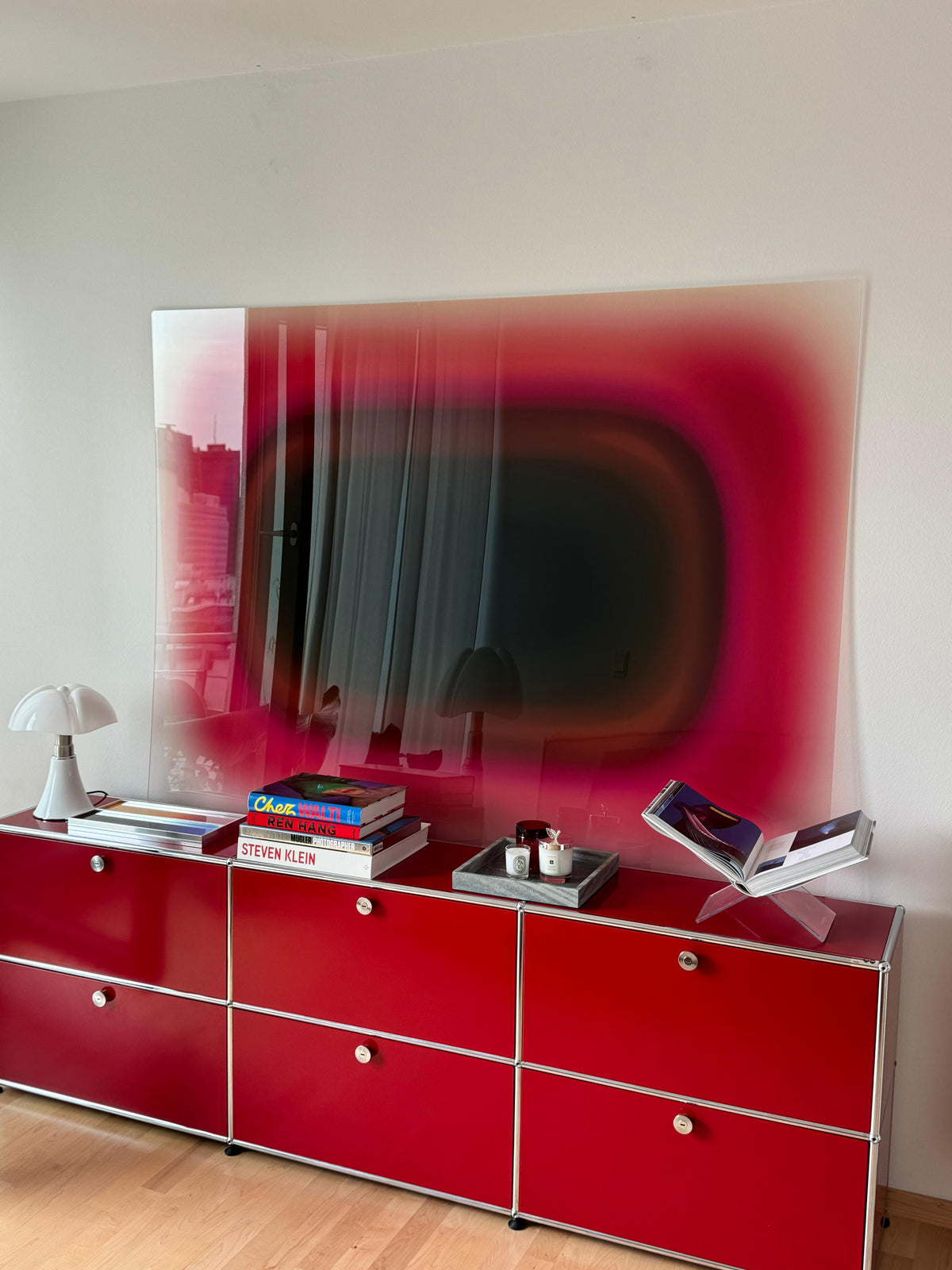 Large-format commissioned artwork by Luis West above a red USM Haller sideboard