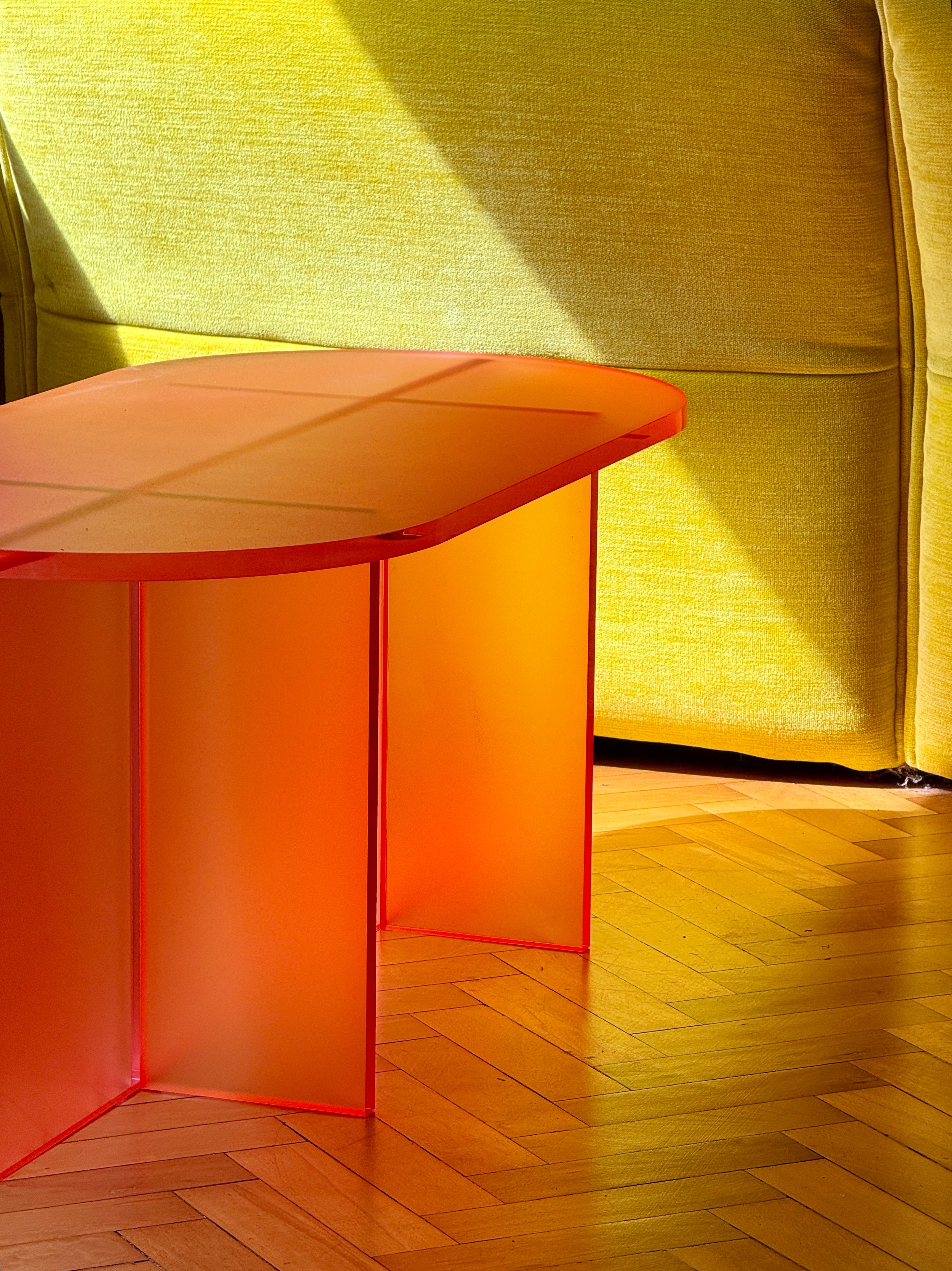 FROSTED COFFEE TABLE by Luis West — frosted orange acrylic, a rounded top on two slab legs