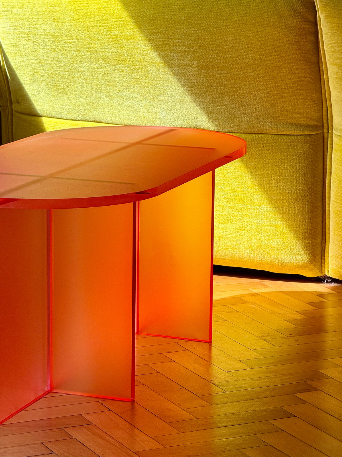 FROSTED COFFEE TABLE by Luis West — frosted orange acrylic, a rounded top on two slab legs