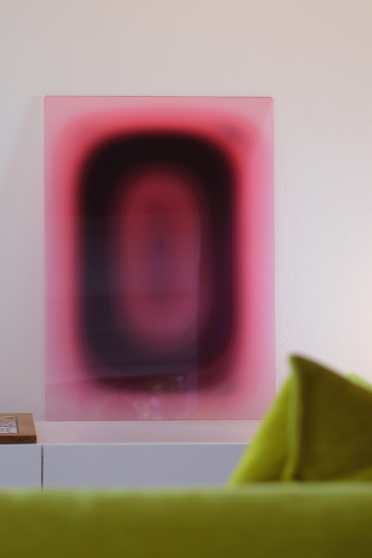 LAVENDER PILL by Luis West on translucent acrylic glass, leaning on a white sideboard in a living room